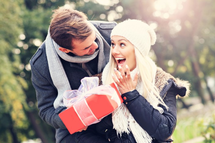 Young couple with a present in the park
