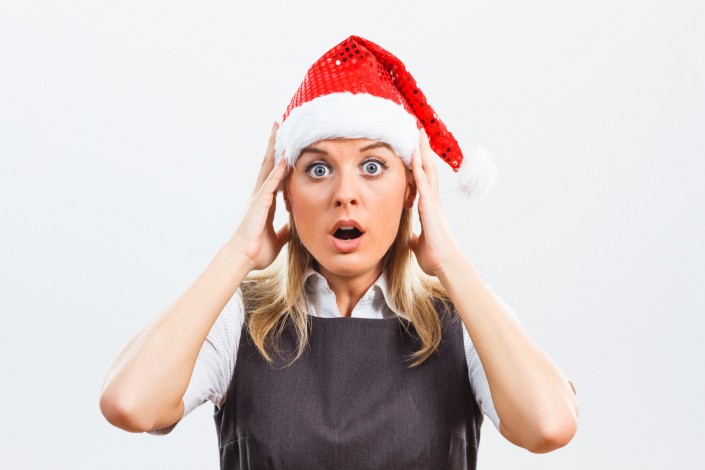 Shocked Business woman with Santa Hat in panic