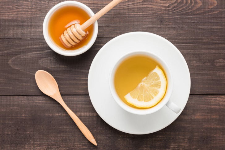 Tea with lemon and honey on the wooden background