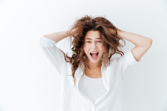 Young brunette woman with long hair shouting
