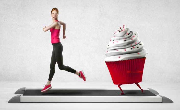 Woman running away from a cupcake