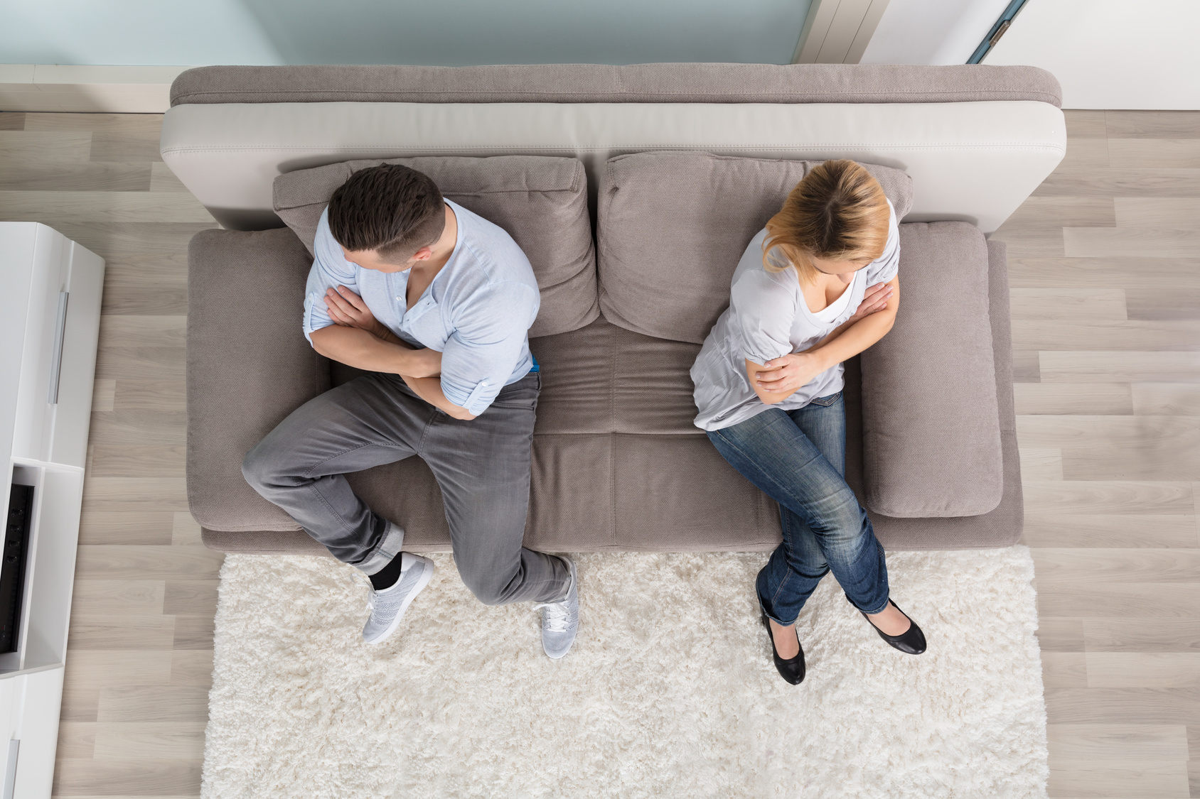 Upset Couple Sitting On Couch