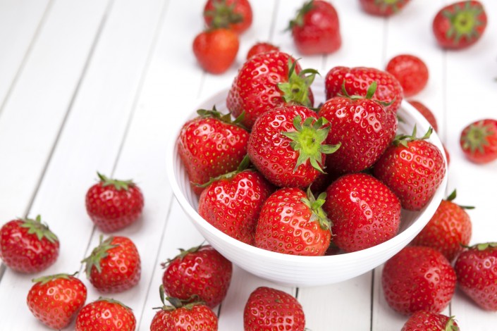 Strawberry on white wooden background. Copy space, top view