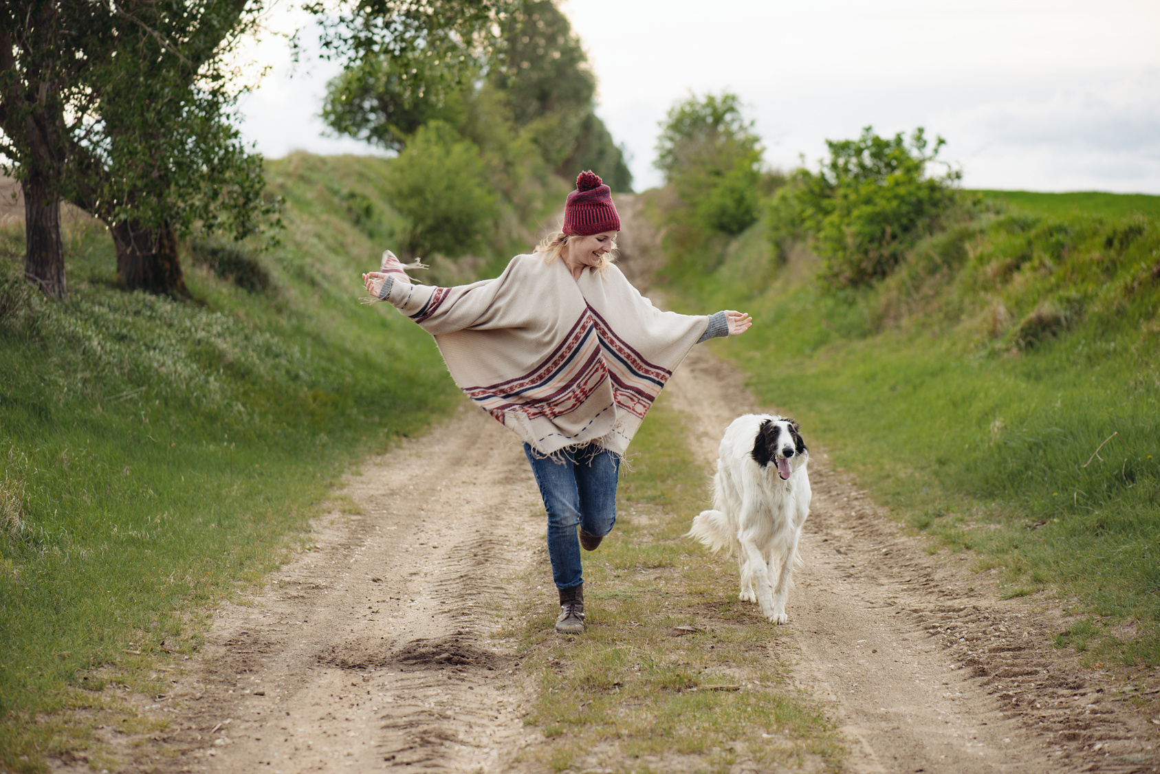 Young woman run with dog outdoor