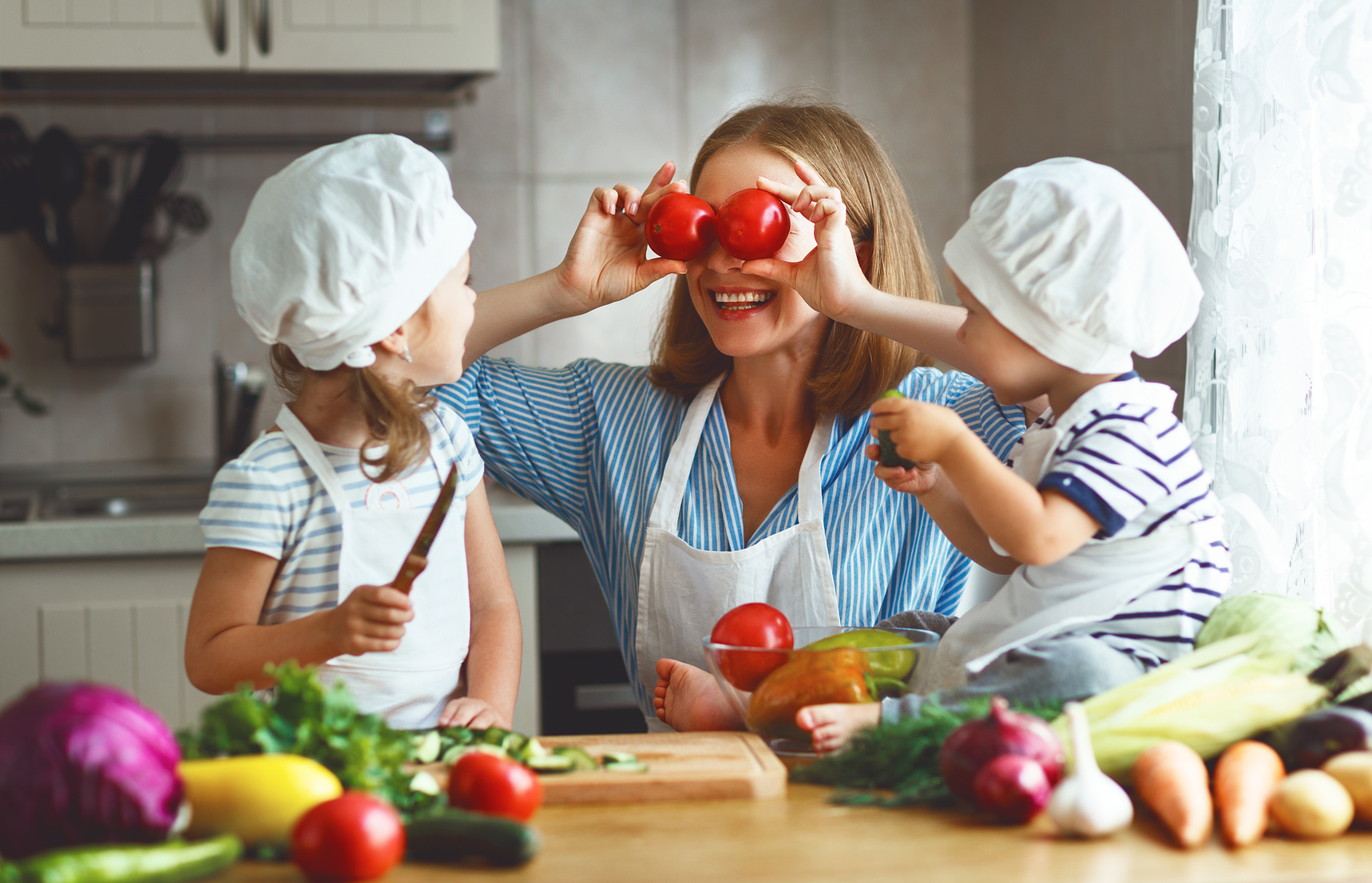 Healthy eating. Happy family mother and children prepares  vegetable salad