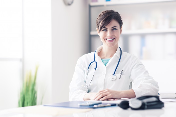 Doctor working at office desk