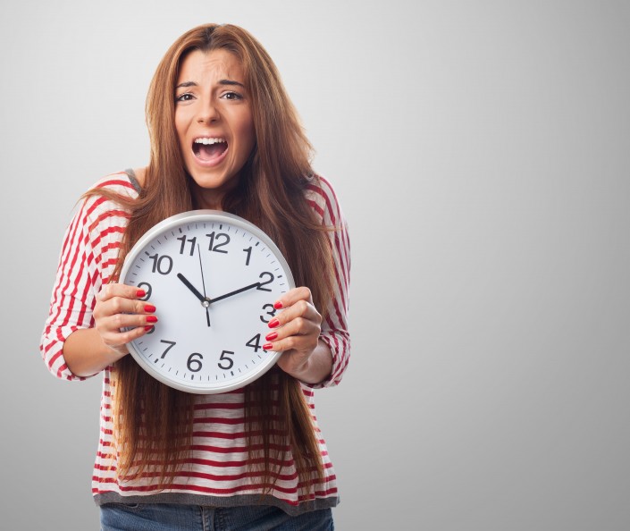 portrait of a pretty woman holding a clock