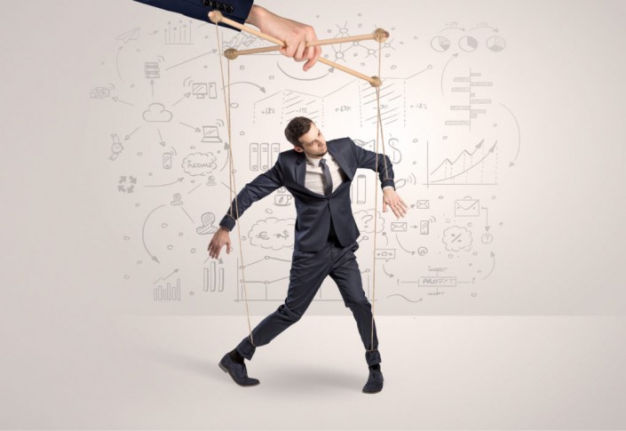 Little businessman controlled from above by another big hand