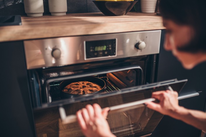 woman-checking-pie-in-oven