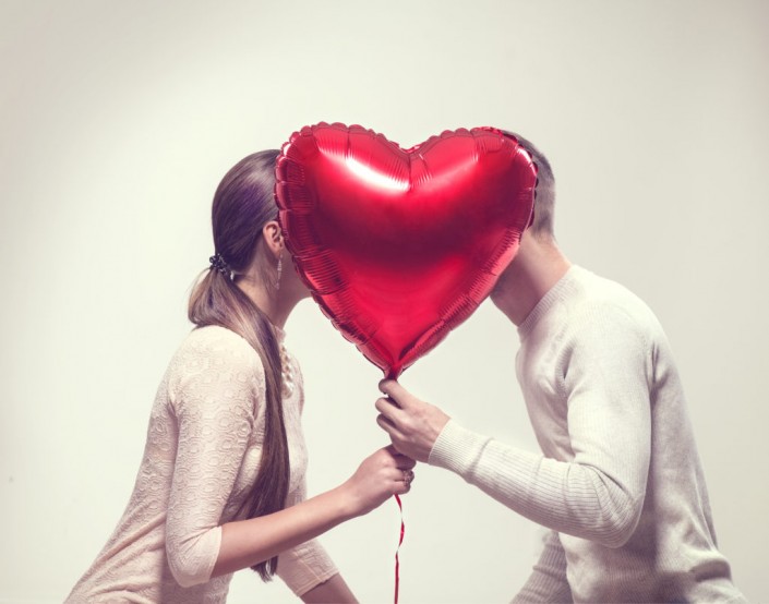 Valentine Couple. Beauty Girl and her Handsome Boyfriend holding