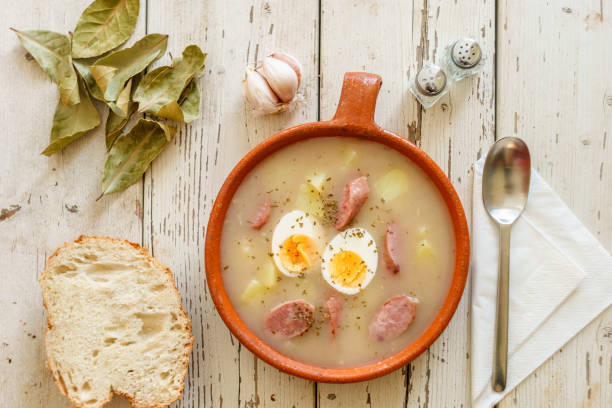Traditional polish soup called Zurek with eggs and sausage surrounded by spices