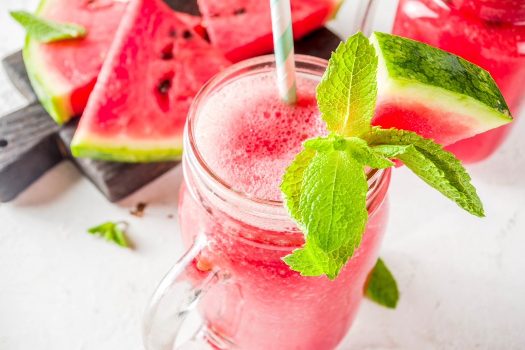 Cold summer drink. Homemade watermelon smoothie. White concrete or stone background copy space