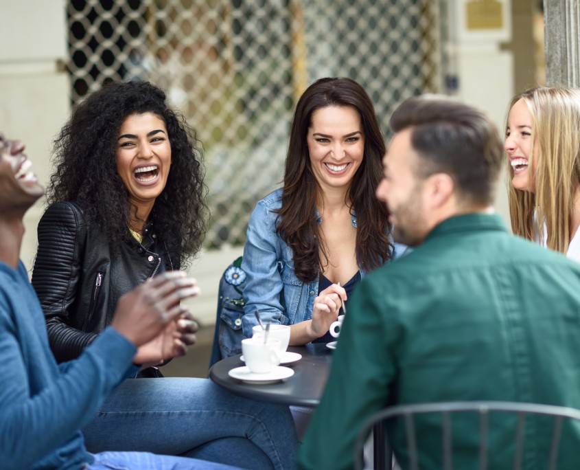 Multiracial group of five friends having a coffee together