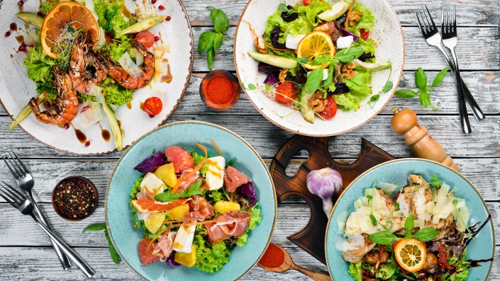 A set of salads. In the plate. Rustic style. Top view. Free space for your text.