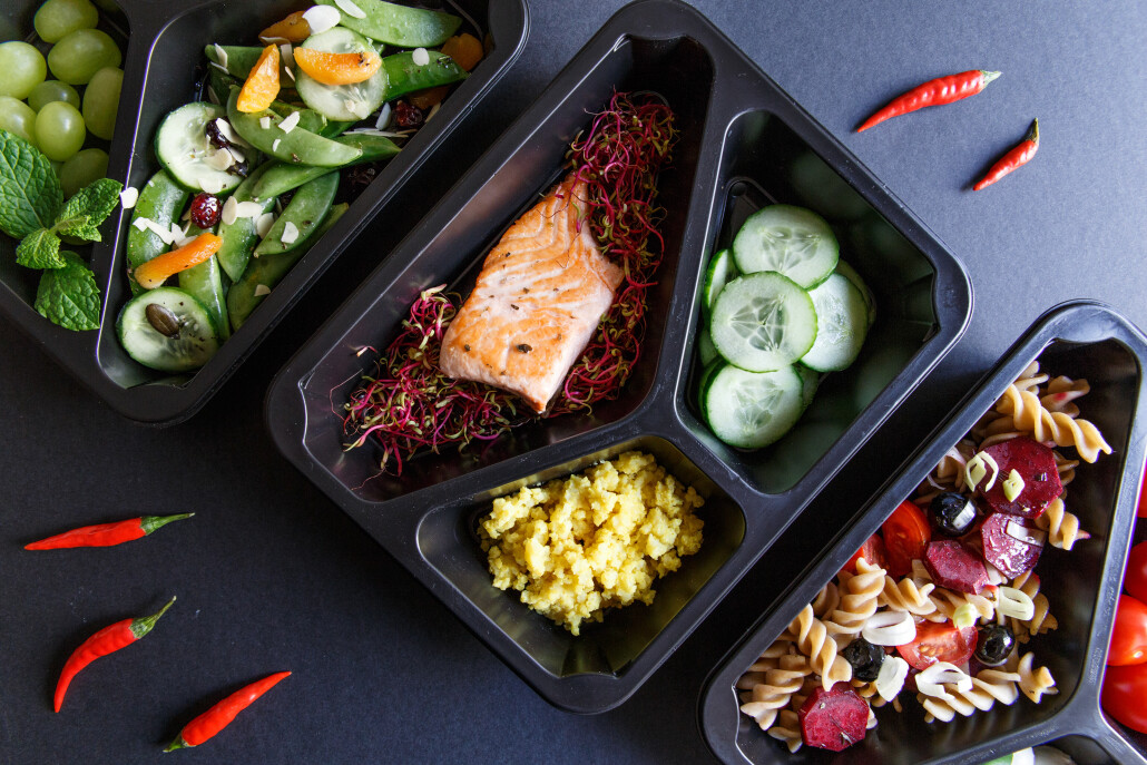Healthy food and diet concept. Dietary catering. Restaurant dish delivery. Fitness meal. Take away. Fit and eat. Weight loss nutrition in foil boxes.