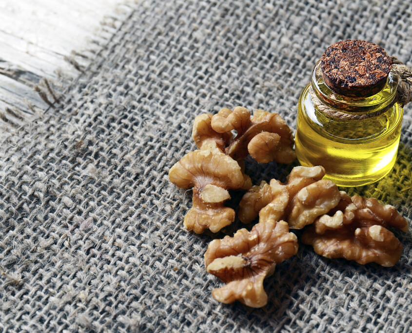 walnut-oil-with-peeled-walnuts-on-burlap-cloth